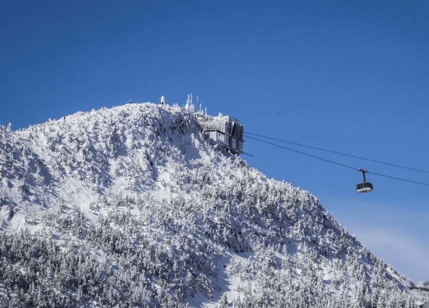 tram leading up to mountain covered in snow tram leading up to mountain covered in snow