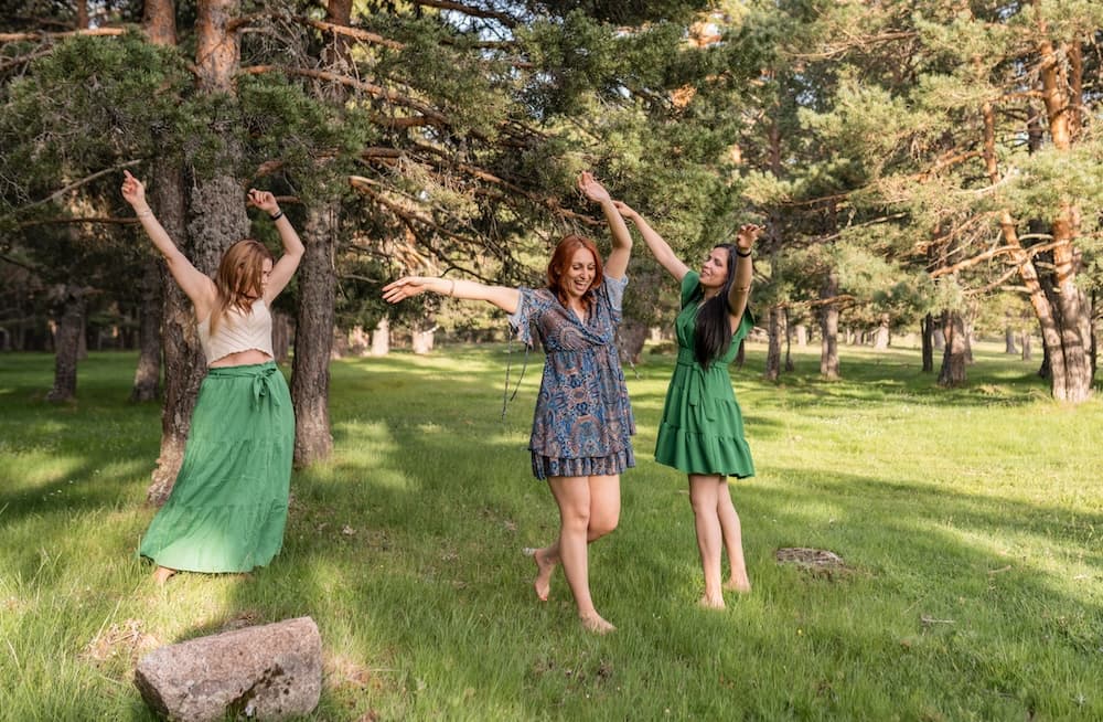 Three women frolicking on the lawn in a garden in Vermont Three women frolicking on the lawn in a garden in Vermont